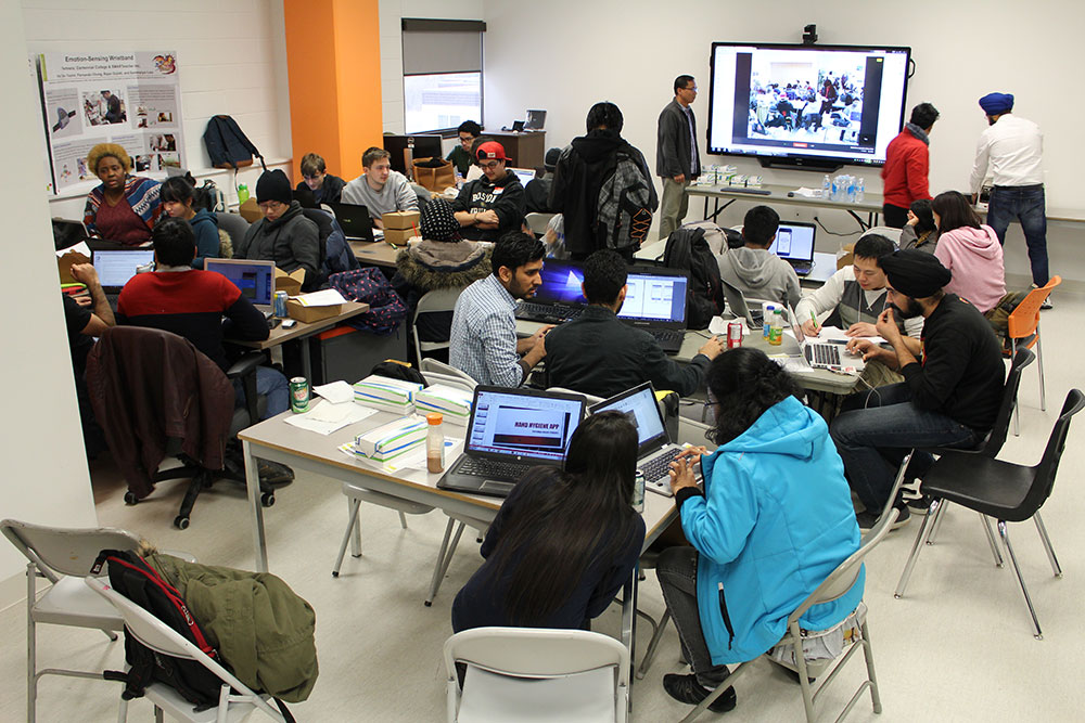 Teams get busy at a recent Hackathon at Centennial College’s Wearable, Interactive and Mobile Technologies Access Centre in Healthcare (WIMTACH), established last year with a $1.75-million federal grant. (photo courtesy Centennial College)